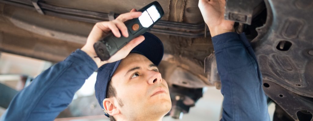 Mechanic inspecting a lifted car - MOT Testing Huntingdon
